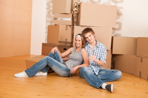Moving team handling boxes safely during a van loading operation