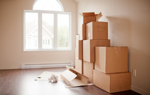 Local removals team carrying furniture through a North London residential street
