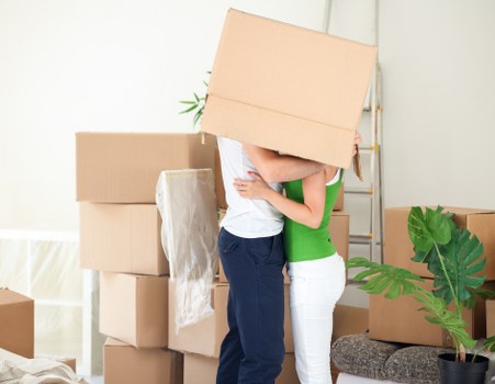Packed moving boxes and furniture ready for transport in North London