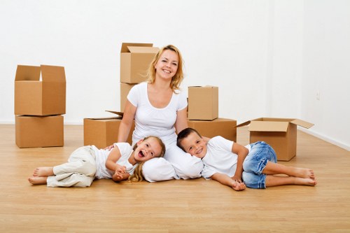 Careful moving of furniture through a narrow hallway in Tufnell Park