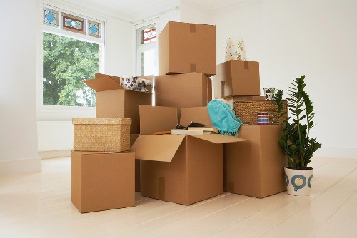 Business relocation setup with boxes, desks, and equipment in a new workspace